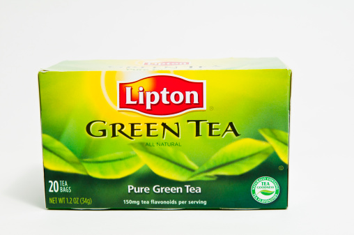 Marietta GA USA - January 12, 2012: Box of Lipton Green Tea bags.  100 percent natural green tea.  All natural green tea is made of the finest tea from around the world.  Studies suggest that drinking green tea may help maintain normal, healthy heart function.  Lipton is one of the world's great refreshemnt brands, with tea-based drinks including leaf tea and other healthy refreshing alternatives to soft drinks.