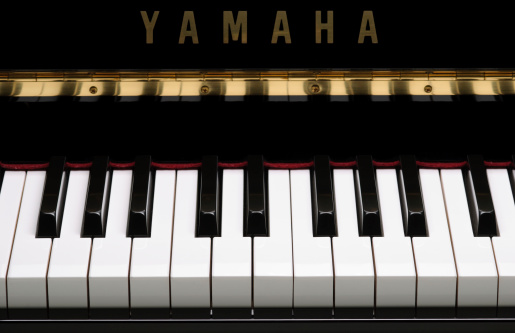 Rustington, United Kingdom - May 30, 2011: The central portion of the keyboard of a Yamaha P121N upright piano.