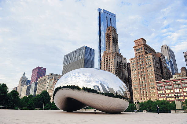 Cloud Gate in Chicago "Chicago, Illinois, USA - September 29, 2011: Cloud Gate closeup in Millennium Park with Chicago skyline and skyscrapers." millennium park chicago stock pictures, royalty-free photos & images