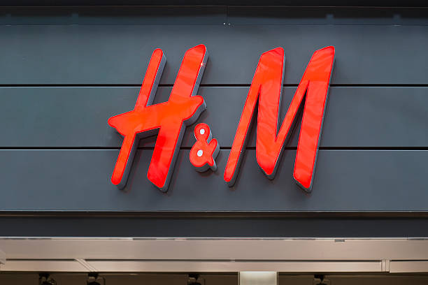 Illuminated sign of H&amp;M in Wiesbaden, Germany Wiesbaden, Germany - March 19, 2011: Illuminated sign of H&amp;amp;amp;M in Wiesbaden, Germany. H&amp;amp;amp;M (full name: Hennes &amp;amp;amp; Mauritz) is a Swedish retail-clothing company. h and m stock pictures, royalty-free photos & images