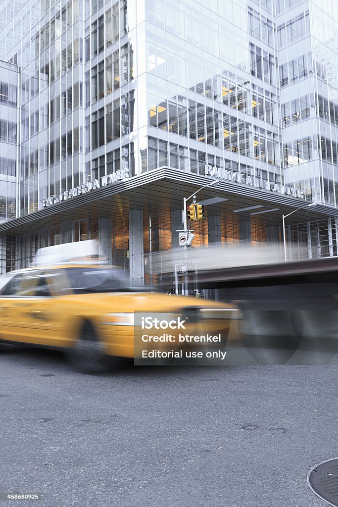 Bank of America Manhattan, New York, USA - March 7, 2011: A New York yellow cab is zooming past the Bank of America building in Manhattan, New York. Long exposure shot to capture the dynamic motion of the taxi. Blurred Motion Stock Photo