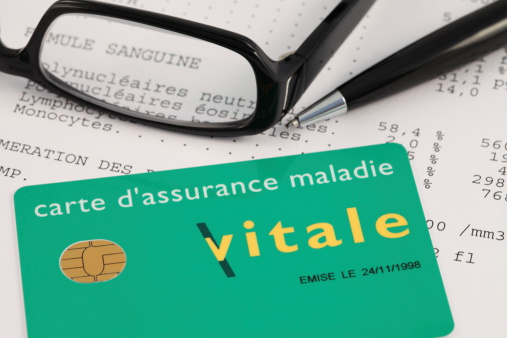 Paris, France - November 28, 2011 : French Carte Vitale (Social Security Card) with data chip on a document analyzing blood samples. The Carte Vitale is the health insurance card health insurance in France.