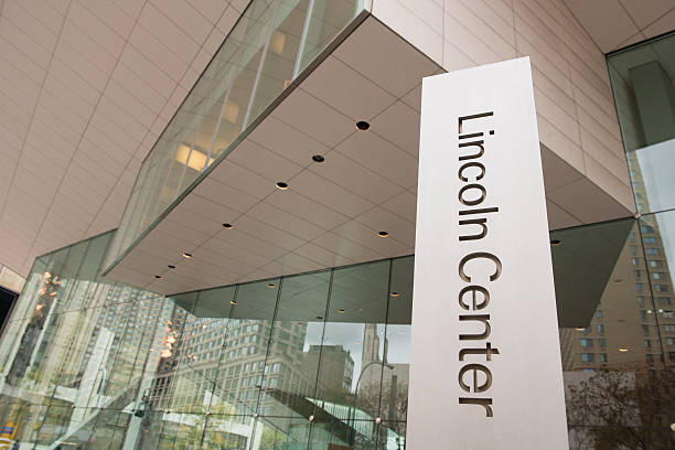 New York City Lincoln Center Entrance Glass Architecture "New York City, United States - October 27, 2012: The modern entrance to the Lincoln Center is clearly marked and reflects several buildings." columbus avenue stock pictures, royalty-free photos & images