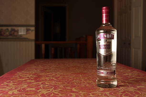 Smirnoff Vodka Calgary, Canada - June 13, 2011: A bottle of Smirnoff Vodka, raspberry flavoured. Smirnoff is a brand of vodka now owned and produced by the British company Diageo. Smirnoff Vodka stock pictures, royalty-free photos & images