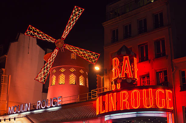 Le Moulin Rouge cabaret in the night on Paris Paris, France - February 8, 2012: Le Moulin Rouge cabaret in the night on Paris. The moulin rouge is a cabaret built at the end of 1800 situated in Montmartre. In this zone there are some red light night bar and sexy shop. place pigalle stock pictures, royalty-free photos & images