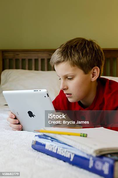 Middle School Boy Using An Ipad While Doing Homework Stock Photo - Download Image Now