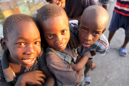 Port-Au-Prince, Haiti - February 13th, 2010 : Young Haitian children playing together near an open bazaar street. 