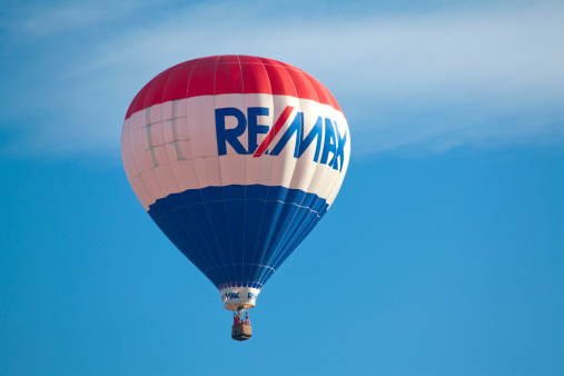 Readington, NJ, USA - July 30, 2011: Since its debut in 1978, the RE/MAX balloon has made thousands of appearances at ballooning festivals, sporting events, and charitable functions around the world. This Remax Logo balloon is floating through crystal blue skies on a picture perfect day at the Readington Balloon Festival