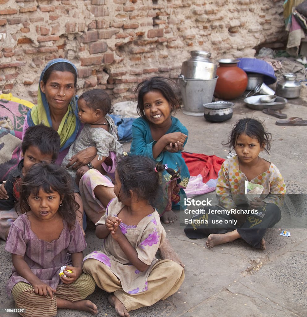 Life on the street "Ahmedabad, India - October 31, 2007: Woman and group of children living in poverty on the street in Ahmadabad, Gujarat, India. It is a common sight in India to find people living on the streets due to poverty." India Stock Photo