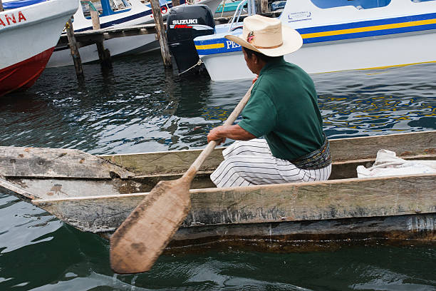 Mayan Fisherman leaving dock Guatemala stock photo