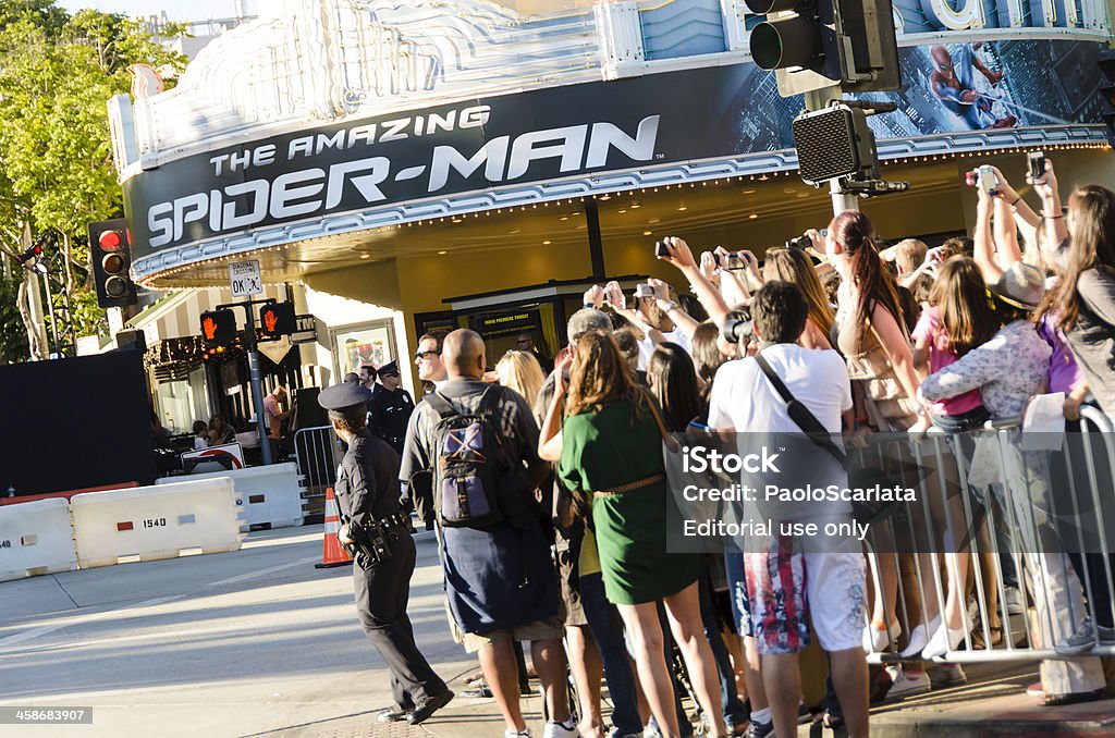 Fans Taking Photos at "The Amazing Spider-Man" Movie Premiere "Los Angeles, California, USA - June 28, 2012: Fans taking photographs with their cameras and cell phones at the premiere of the film ""The Amazing Spider-Man"". The event has taken place at the Fox Village Theatre and at the facing Bruin Theatre (visible in the picture) located in the Westwood Village district." Movie Theater Stock Photo