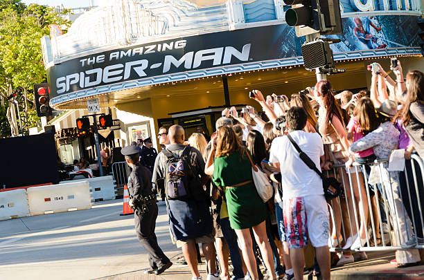 Fans Taking Photos at "The Amazing Spider-Man" Movie Premiere "Los Angeles, California, USA - June 28, 2012: Fans taking photographs with their cameras and cell phones at the premiere of the film ""The Amazing Spider-Man"". The event has taken place at the Fox Village Theatre and at the facing Bruin Theatre (visible in the picture) located in the Westwood Village district." theater marquee red carpet movie theater movie stock pictures, royalty-free photos & images