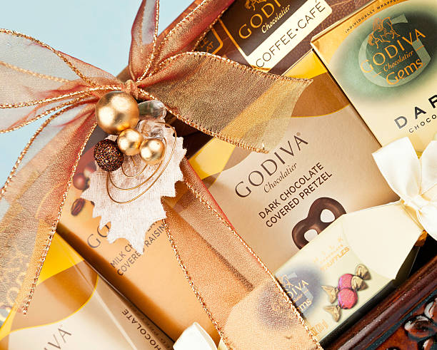 A wicker gift basket of baked goods including cookies and a small loaf of sweet bread.