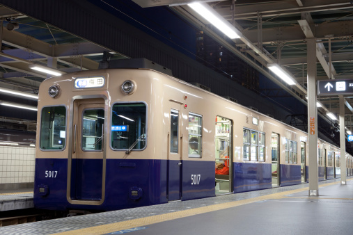 Osaka, Japan - September 10, 2011 : Hanshin Electric Railway train parked at Amagasaki Station, Osaka, Japan. This train is going to Umeda. Some passengers are in the train.