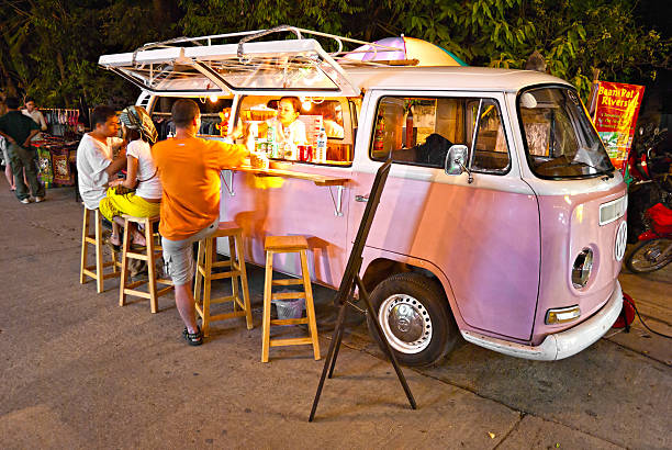 Chiang Mai, Thailand - November 05, 2011: A Vintage pink Volkswagen Bus transformed in a mobile bar for serving refreshing drink to tourists.
