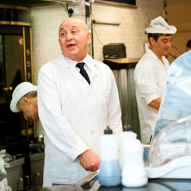 London, England - May 4, 2011: Chief cook jokes with customers in Poppies, a Fish and chips take away in Spitalfields market. The Old Spitaldields market has recently been renewed and is now one of the London's top markets, where one can find fashion, food, vintage and general market items.