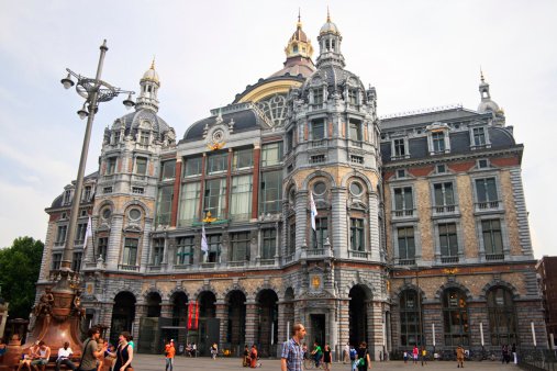 Antwerp, Belgium - July 1st, 2010: Exterior view of historical Antwerpen-Centraal (Antwerp Central) railway station. Tourists waiting and walking pass by the railway station.