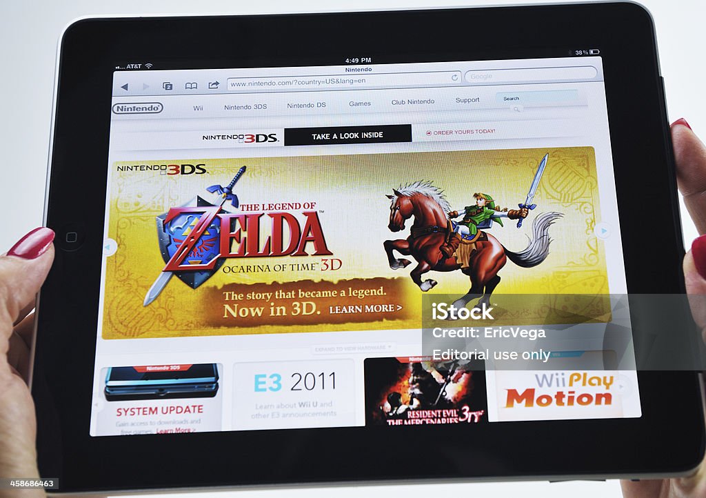 Woman Holding an iPad Displaying a Nintendo Video Game Raleigh, NC - USA - June 27, 2011: Woman Holding an iPad Displaying a Nintendo Video Game. Gambling Stock Photo