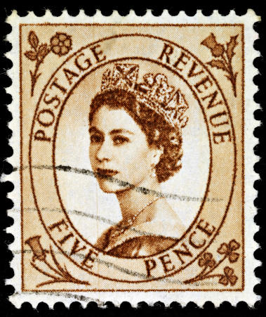 Gomel, Belarus - March 24, 2013: Postage stamp. A stamp printed in UK shows image of Elizabeth II is the constitutional monarch of 16 sovereign states known as the Commonwealth realms, in blue, circa 1989.