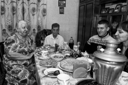 Volgograd, Russian Federation - January 16,  2011: Grandmother Svetlana Ustimova (75) and Grandfather Vladimir Ustimov (75) (married for 50 years and Stalingrad battle survivors) having their grandchildren for a sunday family lunch in their Volgograd appartment.