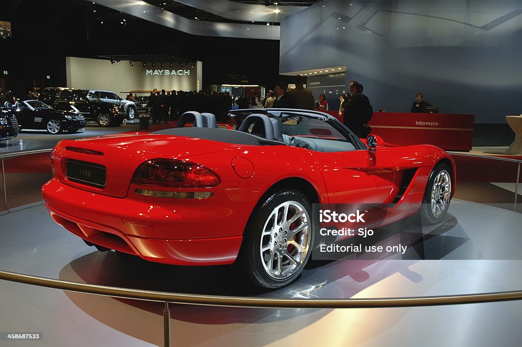 Dodge Viper American sports car rear view Amsterdam, The Netherlands - February 9, 2005: Red Dodge Viper on display at the 2005 Amsterdam Motor Show. People in the background are looking at the cars. Dodge - Vehicle Brand Name Stock Photo