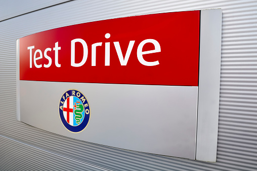 Nunspeet, The Netherlands - August 7, 2011: Alfa Romeo Test Drive fitted to a wall outside a dealership. Alfa Romeo is an Italian car manufacturer.