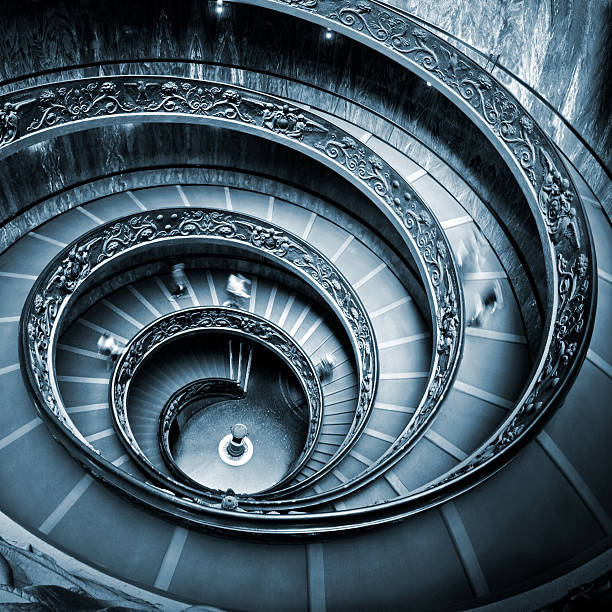 Rome, Italy - 11 September, 2010: The old stairway inside the Vatican museum with moving people in Rome, Italy