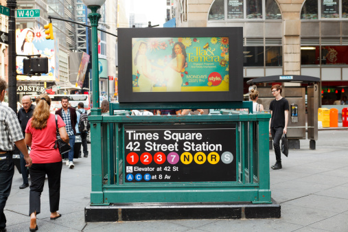 New York, New York, USA - August 18, 2011: An entrance to the Times Square 42nd Street Subway Station located on the corner of 7th Avenue and 40th street in New York City. Pedestrians can be seen.