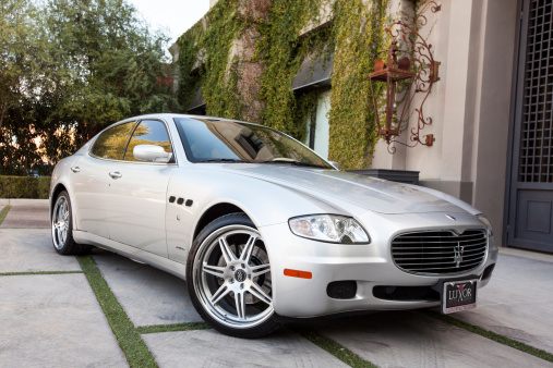 Scottsdale, United States - January 31, 2012: A phot of a silver 2005 Maserati Quattroporte sedan. The Quattroporte is a very luxurious sedan and this particular one is silver with custom wheels.