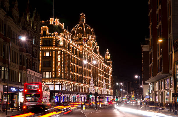 Harrods department store at night, Knightsbridge, London "London, United Kingdom - November 11, 2012: Harrods department store in Knightsbridge on the Brompton Road, the store has been decorated for Christmas. Harrods was founded in 1834 it has become world famous and is a popular tourist attraction. The streets are busy with traffic and late night shoppers." harrods photos stock pictures, royalty-free photos & images