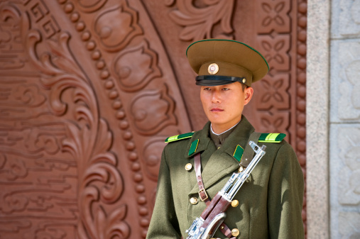 Pyongyang, North Korea - Oct 05, 2009: A guard standing in front of palace gate. This palace was built specially for housing the gifts received by the leading father and son of North Korea.