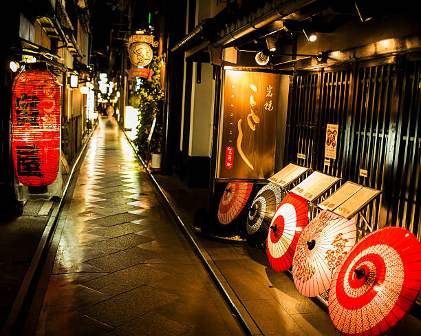 Kyoto, Japan - October 18, 2012: Restaurants in Pontocho at night. Ponto-cho is a Hanamachi district in Kyoto well known for the traditional architecture, tea houses and Geishas that can be found here. Some Geisha houses are located here and they can work here in the many restaurants and tea houses.