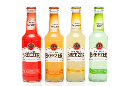 Trebnje, Slovenia - June 16, 2011 : Four bottles of Bacardi Breezer, each of different colour and taste, Tropical Lime, Tropical Pineaple, Tropical Orange and Ruby Grapefruit with 4% of alcohol. Country of origin and packing - United Kingdom. Manufacturer - Bacardi Brown-Forman Brands, Kings Worthy, Winchester, SO23 7TW. Studio shot on white background.