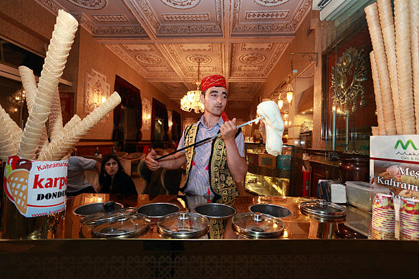 Turkish confectioner prepares an ice cream in the tradition way stock photo