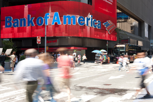 Manhattan, New York USA - July 9, 2011: People and tourist walking by the colorful electronic sign of Bank of America. The sign is one of many colorful signs in Times Square.