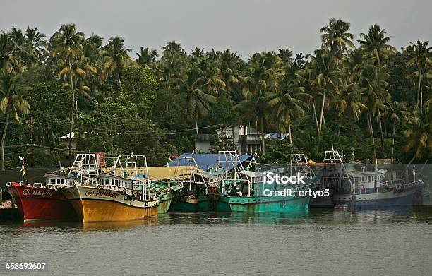 Boats In Dock On A River Stock Photo - Download Image Now - Trawler, Fishing Boat, India