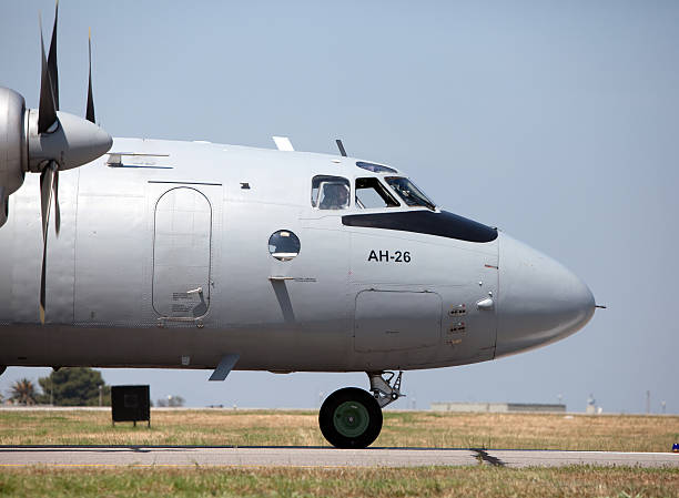 Air Show Turkey 2011 Izmir, Turkey - June 3, 2011 : A side view of a Slovakian Antonov AN - 26 standing on the runway, part of the static aircraft display in the 2011 Air Show Turkey - held in celebration of the 100th anniversary of the Turkish Air Force at the Cigli Air Base, Izmir.The Antonov An-26 (NATO reporting name: Curl) is a twin-engined turboprop military transport aircraft, designed and produced in the USSR from 12 March 1968. antonov an 26 stock pictures, royalty-free photos & images