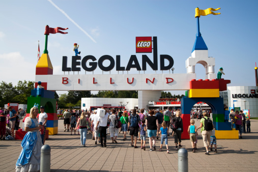 Billund, Denmark - August, 02th 2011: The Legoland sign and logo over the entrance in Billund, Denmark. People are going to the entrance of Legoland.