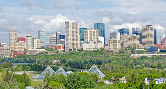 Edmonton, Canada - June 5, 2011: Edmonton Skyline and the greenhouse pyramids of the Muttart Conservatory. This photo is taken across the the North Saskatchawan River and looking north into the center of the downtown area.