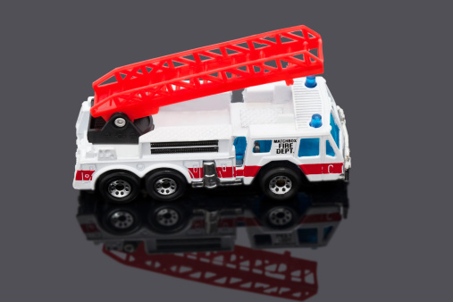 Cinnaminson, New Jersey, USA - April 19, 2011: Hot Wheels is a brand of die cast toy car,  Mattel the toymaker introduced it in 1968. Mattel acquired rights to the Matchbox brand from Tyco. This is the Fire Department Hook and Ladder toy fire truck