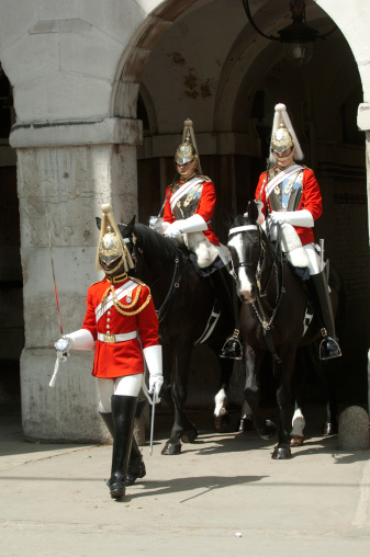London, UK - July 22 2008: Marching troopers of the Household Cavalry on duty at Horse Guards London UK. A black soldier leads the way.