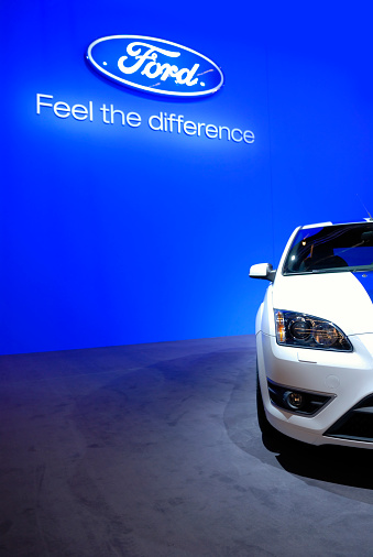 Amsterdam, The Netherlands - March 27, 2007: White Ford Focus ST hatchback on display at the 2007 Amsterdam Motor Show. The Ford logo and slogan \