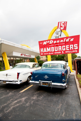 Des Plaines, IL, USA -  August 6, 2011:  First McDonald's franchise, opened in 1955 by Ray Kroc.  Vintage cars are in museum's parking lot.
