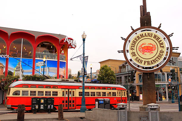 San Francisco: Historical Street Car "San Francisco, United States - August 22, 2013: Fisherman's Wharf of San Francisco and historical street car at Pier 43 with buiness buidlings on the background" fishermans wharf san francisco photos stock pictures, royalty-free photos & images