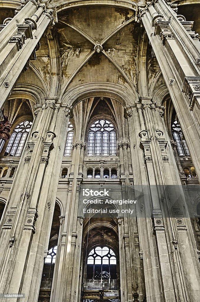 The grand interior of landmark Saint-Eustache church "Paris, France - April 14, 2013: The grand interior of the landmark Saint-Eustache church. St Eustace's is considered a masterpiece of late Gothic architecture" Aisle Stock Photo