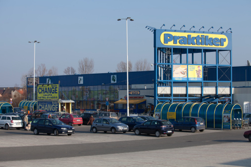 Gyar, Hungary - March 05, 2011: Praktiker hypermarket and its parking lot. Praktiker is a  German hypermarket chain offering home improvement and do-it-yourself goods. Taken on a Saturday afternoon.
