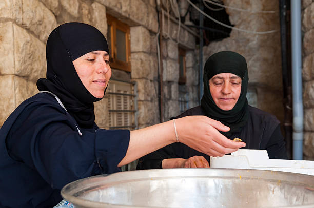 Syrian Christian nuns at Greek Orthodox monastery of St. Thecla Maalula, Syria - June 10, 2010: Two Christian nuns prepare apricots to be made into apricot jam at the Greek Orthodox monastery of St. Thecla (Mar Takla), which is located in the small town of Maalula, one of the few Aramaic-speaking communities in the world. In addition to the grave of Saint Thecla, the convent is home to a small orphanage for girls. greek orthodox stock pictures, royalty-free photos & images