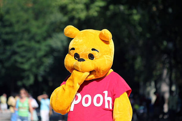 Winnie Pooh Madrid, Spain - 24th August 2011: An actor dressed as Winnie The Pooh entertaining the visitors of Parque del Retiro in Madrid, Spain. winnie the pooh photos stock pictures, royalty-free photos & images