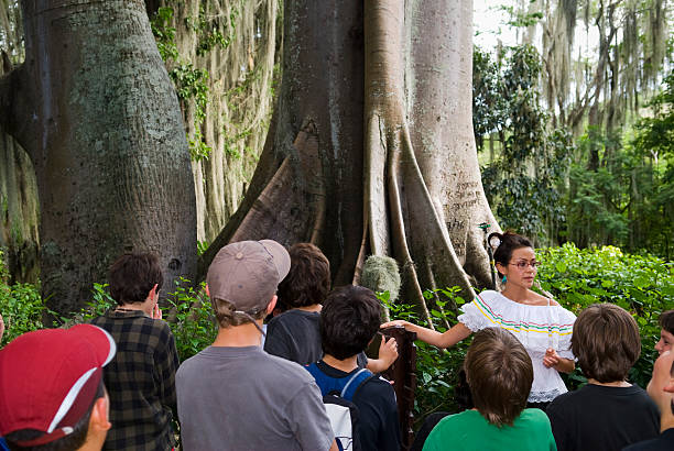 San Gil, Colombia - May 24, 2009: A park guide gives Colombian school children a tour of Parque Natural El Gallineral, a four-hectare botanical garden with giant moss-strewn trees.