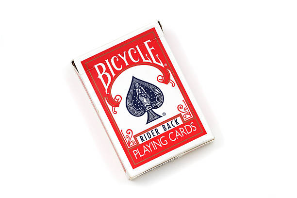 Close-up of a fan of playing cards, showing the corner of the Ace of Diamonds and the red-patterned backs.